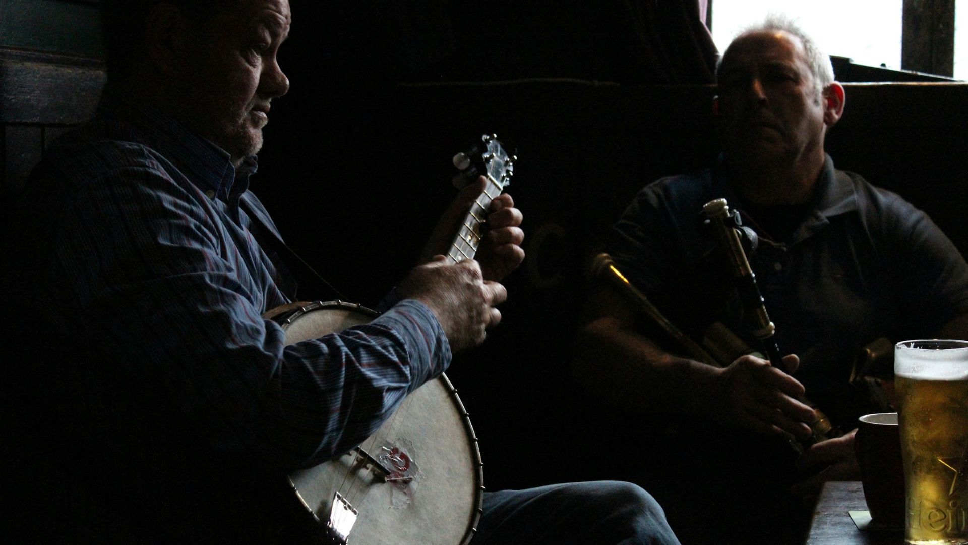 Man playing guitar in an Irish pub