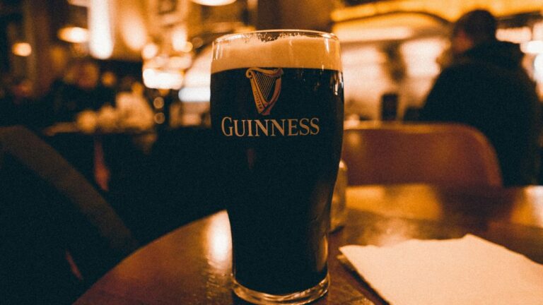 a pint of guiness on a table in a bar
