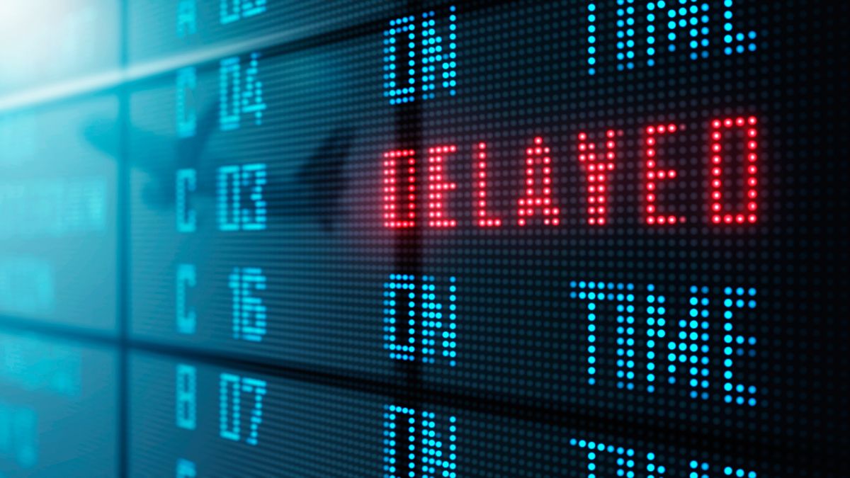 Flight delay notification on an airport display screen.