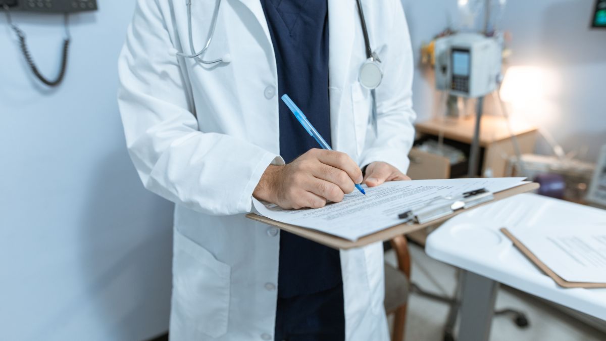 A doctor filling out medical papers