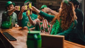 Group of people clinking glasses to celebrate St. Patrick's Day