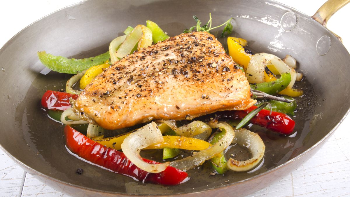 Grilled Irish wild salmon in a pan with roasted vegetables