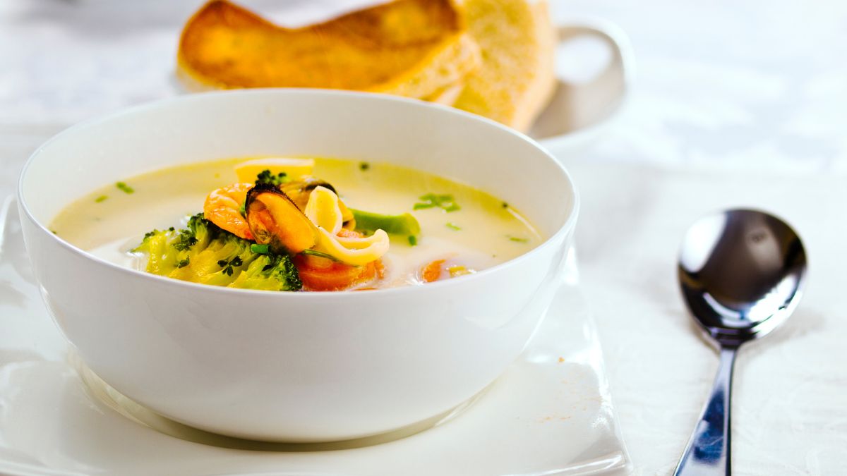 Homemade Irish Seafood Chowder with king prawn, mussels, squid, broccoli, and carrots. It's served with soda bread