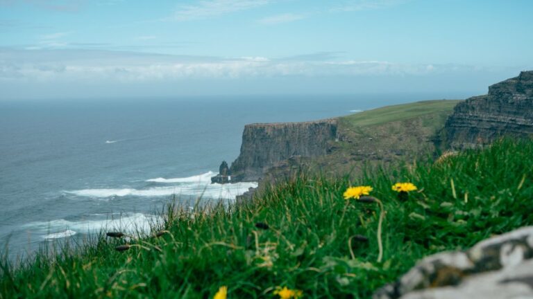 Stunning Cliffs Overlooking Ocean Waves under Clear Blue Sky in Ireland